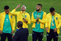 2016 Rio Olympics - Soccer - Victory Ceremony - Men's Football Tournament Victory Ceremony - Maracana - Rio de Janeiro, Brazil - 20/08/2016. Neymar (BRA) of Brazil (2nd L) and teammates receive their gold medals during the medal ceremony. REUTERS/Murad Sezer