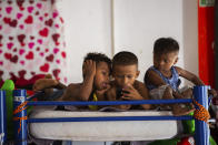 Haitian migrant children watch programing at a shelter, Friday, Sept. 17, 2021, in Ciudad Acuña, Mexico. Haitians crossed the Rio Grande freely and in a steady stream, going back and forth between the U.S. and Mexico through knee-deep water with some parents carrying small children on their shoulders. Unable to buy supplies in the U.S., they returned briefly to Mexico for food and cardboard to settle, temporarily at least, under or near the bridge in Del Rio, a city of 35,000 that has been severely strained by migrant flows in recent months. (Marie D. De Jesús/Houston Chronicle via AP)