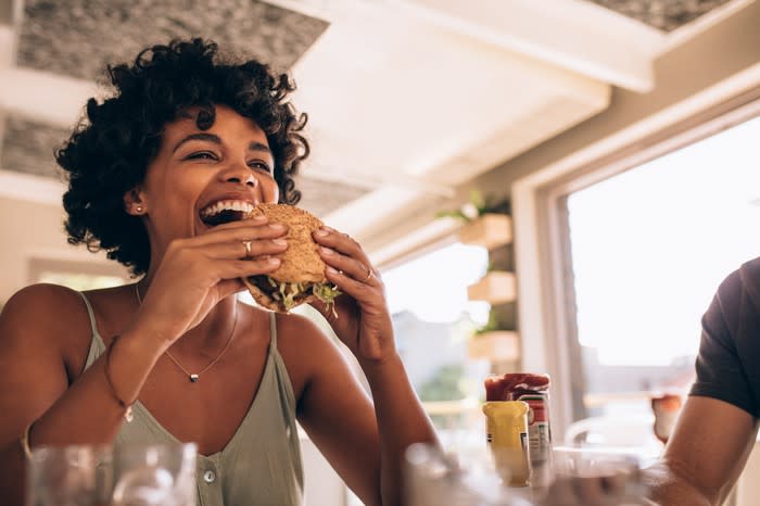 Woman eating a burger.