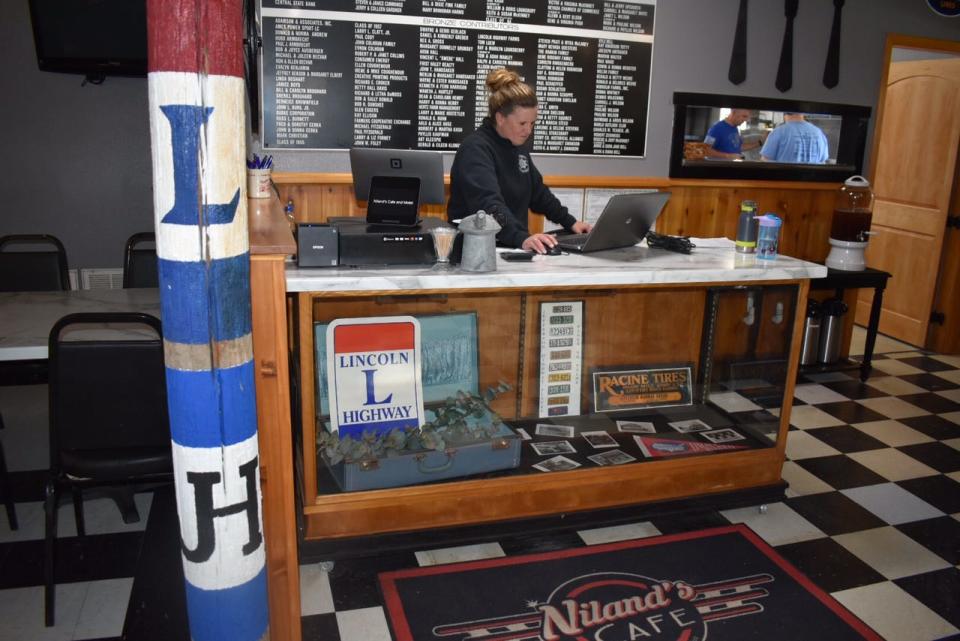 A post inside Niland's Cafe notes its location at the intersection of the historic Lincoln Highway and Jefferson Highway in Colo, Iowa.