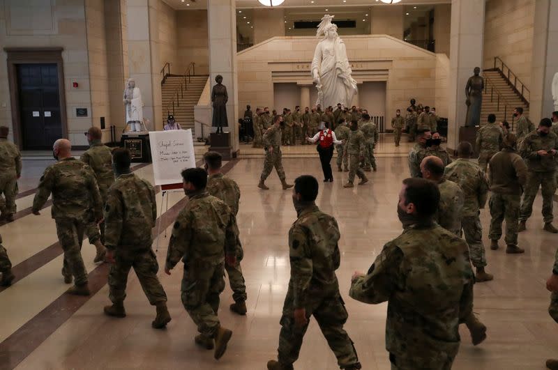 Members of the U.S. National Guard wait to take tours of the U.S. Capitol building in Washington