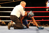 <p>Erin Fitchette is slow to get up as he assisted by the referree in the ring during a match against Mark Sinatra in the NYPD Boxing Championships at the Theater at Madison Square Garden on June 8, 2017. (Photo: Gordon Donovan/Yahoo News) </p>