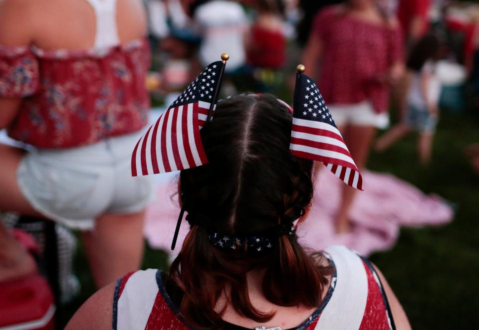 A spectator sports a pair of novel hair accessories at Red, White & Boom!