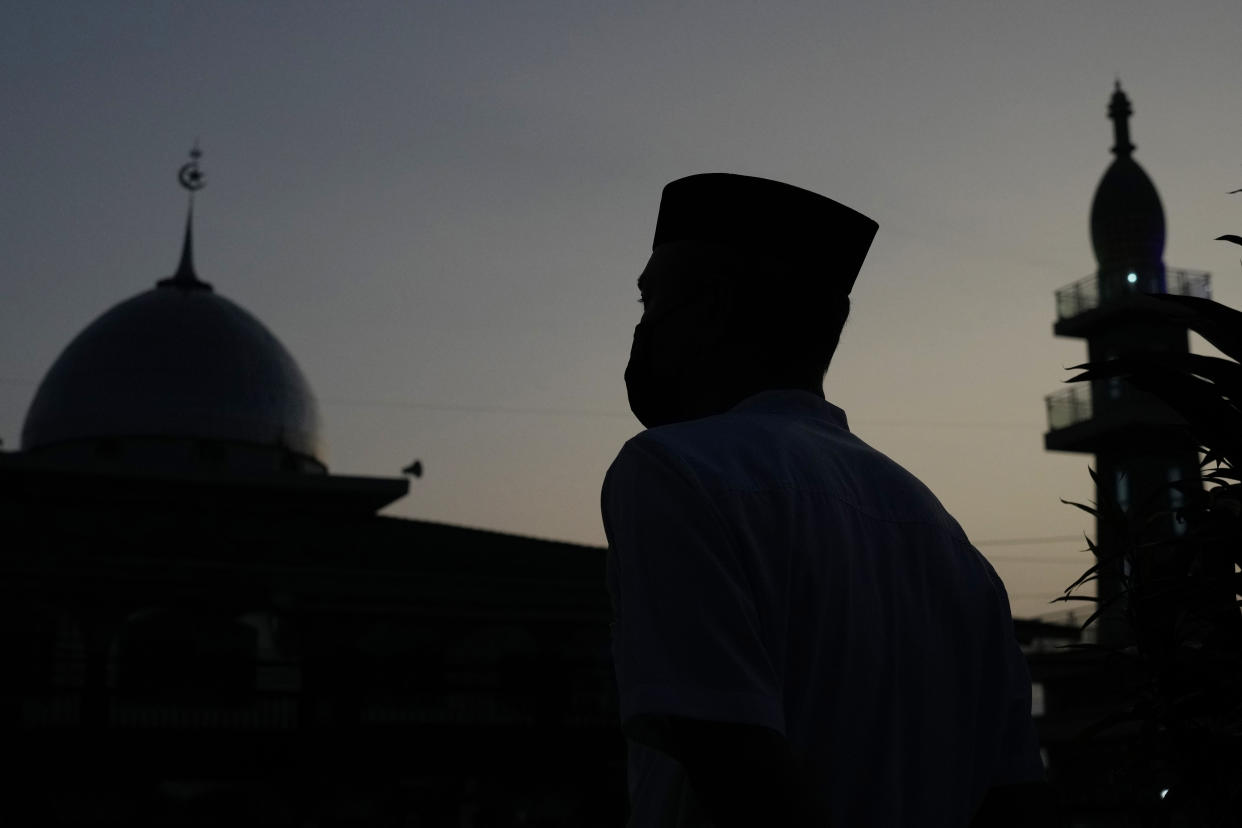 A Muslim heads to a mosque for an Eid al-Fitr prayer marking the end of the holy fasting month of Ramadan on a street in Bekasi, West Java, Indonesia, Monday, May 2, 2022. (AP Photo/Achmad Ibrahim)