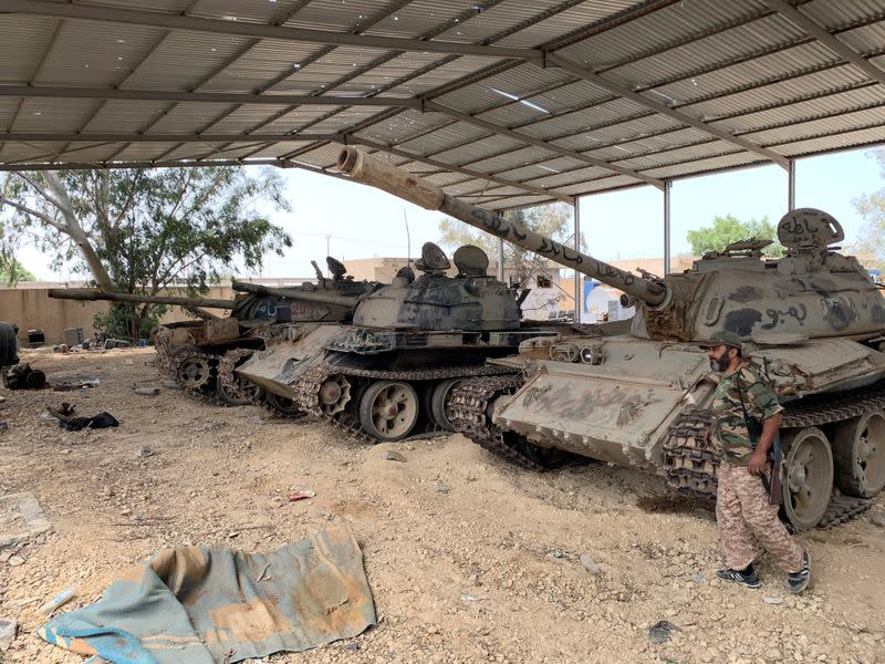 Fighter loyal to Libya's internationally recognised government is seen near confiscated tanks after regaining control over Tripoli