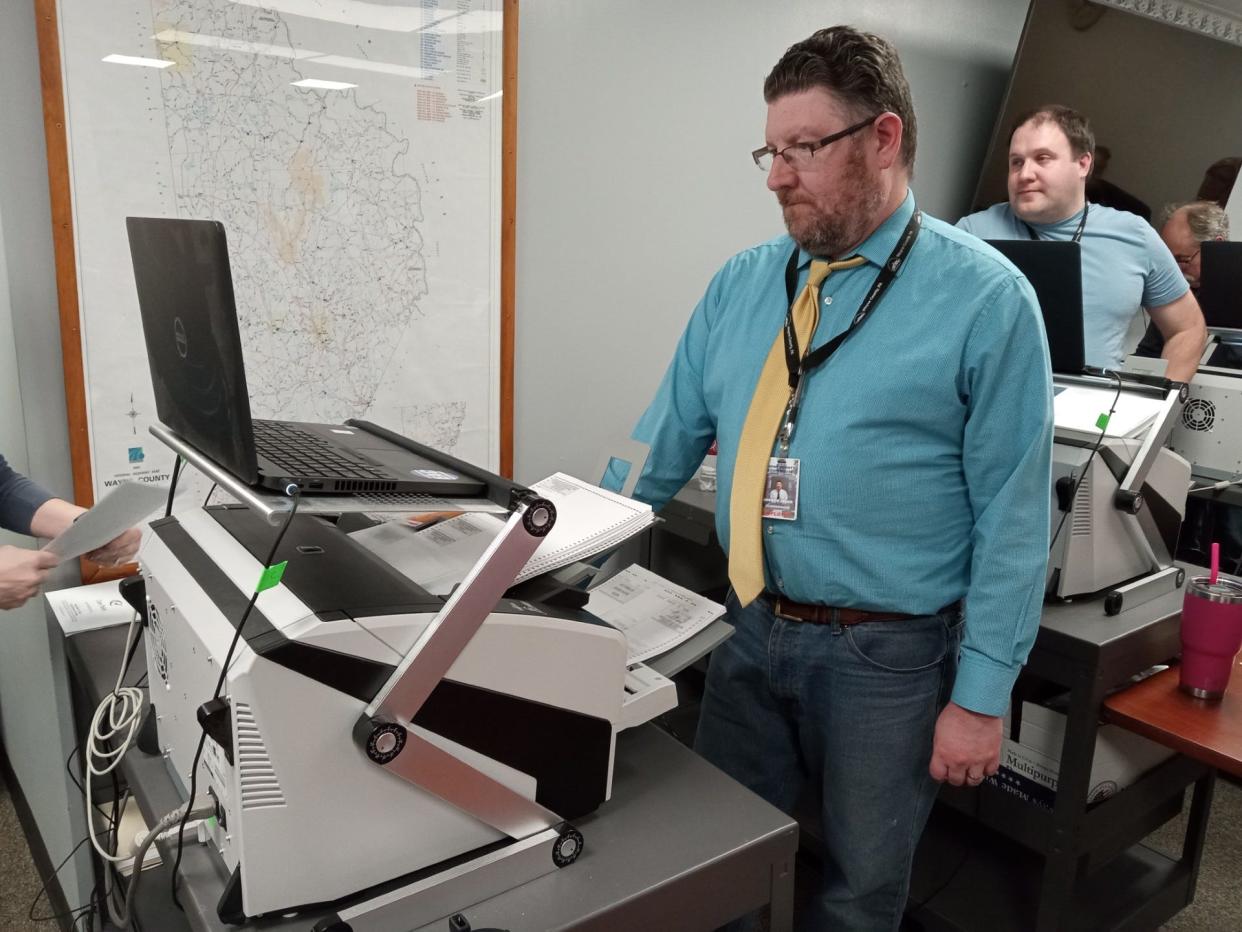 County Clerk Andrew Seder operates one of the automatic ballot scanning machines which count the votes during primary election night on April 23, 2024, at the Wayne County Courthouse. Wayne County had 9,619 ballots cast, for a 29.38% turnout.