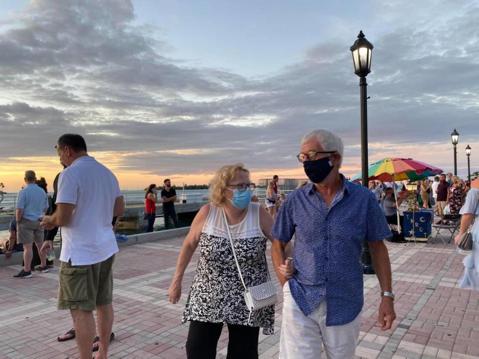 A couple walks through Mallory Square in Key West during Sunset Celebration.