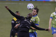 Columbus Crew's Gyasi Zardes, front, and Seattle Sounders' Gustav Svensson vie for a head ball during the second half of the MLS Cup championship game Saturday, Dec. 12, 2020, in Columbus, Ohio. The Crew won 3-0. (AP Photo/Jay LaPrete)