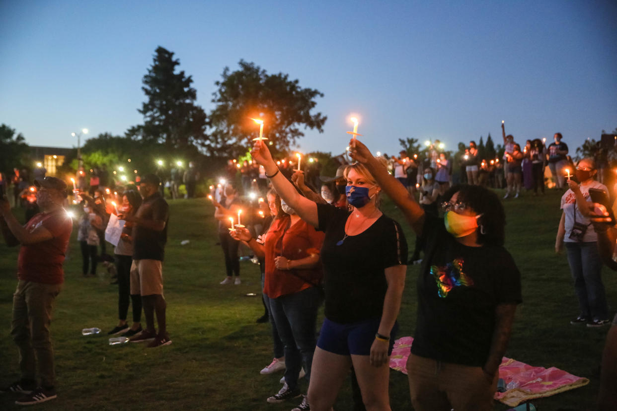 Candles are lit and held at the first Juneteenth celebration at the Corbett Center outdoor stage on New Mexico State campus in Las Cruces on June 19, 2020.