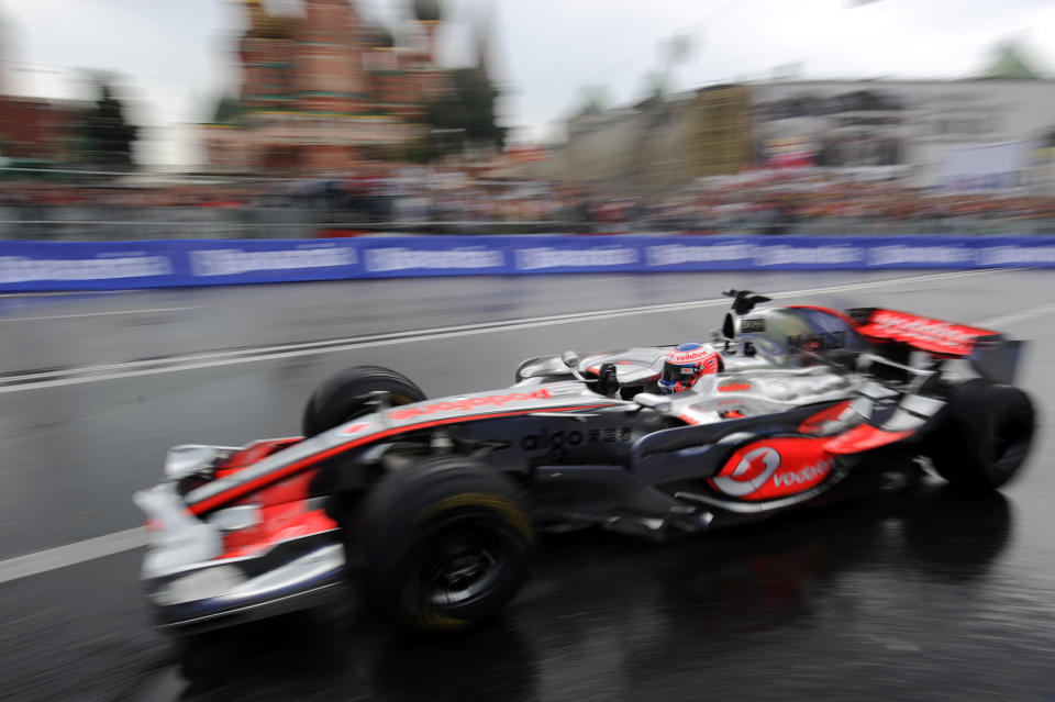 Formula One Vodafone McLaren Mercedes team driver Jenson Button of Britain drives past St. Basils cathedral during the "Moscow City Racing" show on July 17, 2011 in central Moscow. AFP PHOTO / NATALIA KOLESNIKOVA (Photo credit should read NATALIA KOLESNIKOVA/AFP/Getty Images)