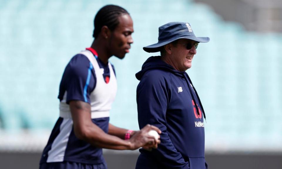Trevor Bayliss (right) looks on as Jofra Archer practices in a nets session.