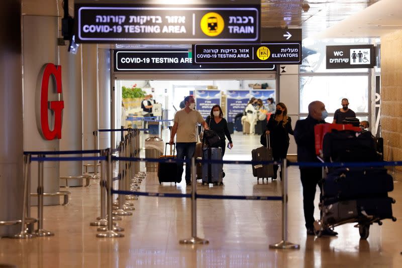 FILE PHOTO: Travellers exit the coronavirus disease (COVID-19) pandemic testing area at Ben Gurion International Airport as Israel imposes new restrictions