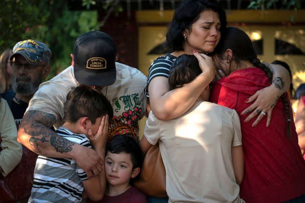 PHOTO: Raquel Martinez, comforts her two daughters while her husband, Daniel Martinez, comforts their sons outside Robb Elementary School, on May 26, 2022, in Uvalde, Texas.  (Wong Maye-e/AP)