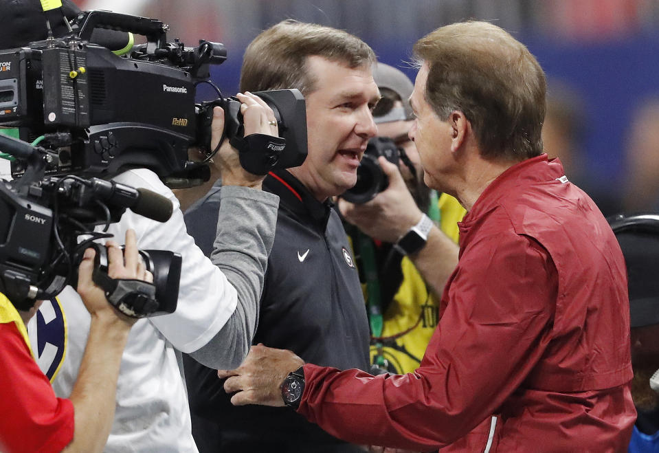 Georgia head coach Kirby Smart, left, speaks with Alabama head coach Nick Saban ahead of the Southeastern Conference championship NCAA college football game between Georgia and Alabama, Saturday, Dec. 1, 2018, in Atlanta. (AP Photo/John Bazemore)