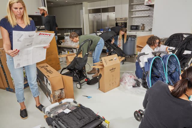 <p>Verywell Family / Tamara Staples</p> Parenting editors putting together strollers to test in the Verywell Family Lab, including Joovy, Yoyo, and Baby Jogger strollers.