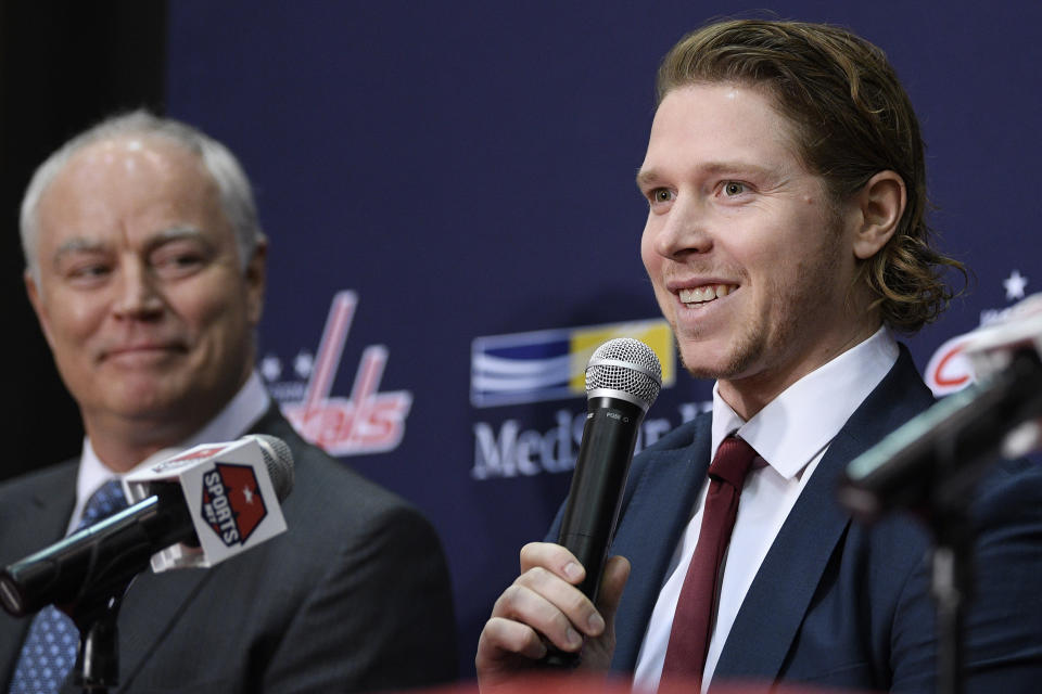 Washington Capitals center Nicklas Backstrom, right, of Sweden, speaks during an NHL hockey news conference about the Capitals re-signing him to a five-year contract, Tuesday, Jan. 14, 2020, in Washington. At left is Capitals general manager Brian MacLellan. (AP Photo/Nick Wass)