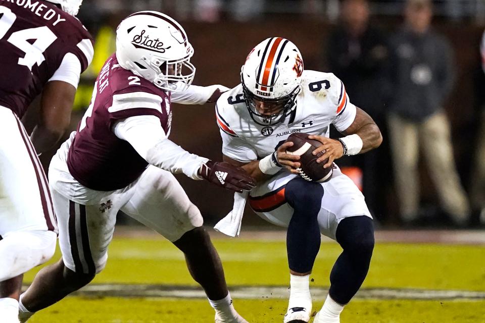 Auburn quarterback Robby Ashford (9) is sacked by Mississippi State linebacker Tyrus Wheat (2) during the first half of an NCAA college football game in Starkville, Miss., Saturday, Nov. 5, 2022.(AP Photo/Rogelio V. Solis)