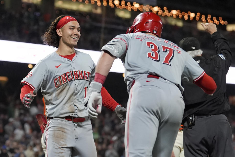 Cincinnati Reds' Stuart Fairchild, left, is congratulated by Tyler Stephenson (37) after hitting an inside-the-park home run against the San Francisco Giants during the eighth inning of a baseball game in San Francisco, Friday, May 10, 2024. (AP Photo/Jeff Chiu)