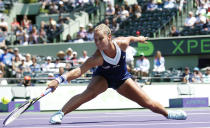 Dominika Cibulkova, of Slovakia, returns the ball to Agnieszka Radwanska, of Poland, at the Sony Open Tennis tournament in Key Biscayne, Fla., Wednesday, March 26, 2014. (AP Photo/Joel Auerbach)