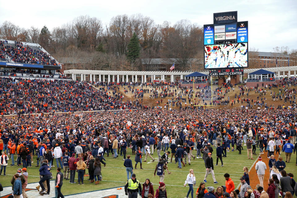 CHARLOTTESVILLE, VA - NOVEMBER 29: Fans of the Virginia Cavaliers rush the field after defeating the Virginia Tech Hokies during a game at Scott Stadium on November 29, 2019 in Charlottesville, Virginia. (Photo by Ryan M. Kelly/Getty Images)