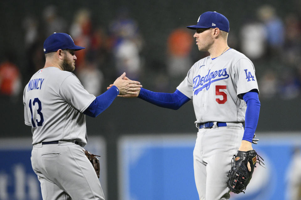 Los Angeles Dodgers' Freddie Freeman (5) and Max Muncy (13) celebrate after a baseball game against the Baltimore Orioles, Tuesday, July 18, 2023, in Baltimore. The Dodgers won 10-3. (AP Photo/Nick Wass)