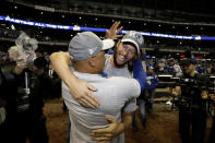 Los Angeles Dodgers' Clayton Kershaw celebrates with manager Dave Roberts after winning Game 7 of the National League Championship Series baseball game against the Milwaukee Brewers Saturday, Oct. 20, 2018, in Milwaukee. The Dodgers won 5-1. (AP Photo/Matt Slocum)