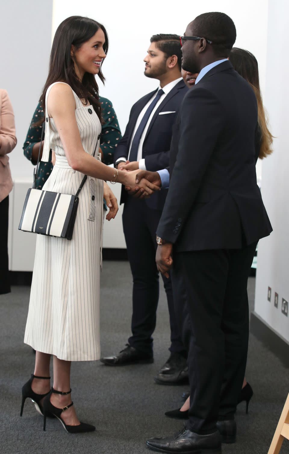 Markle once again broke royal protocol by sporting a cross-body bag and by removing her jacket from her shoulders inside the event. Photo: Getty Images