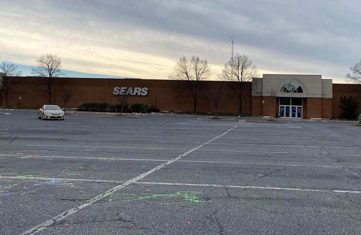 Parking lot with one car on a gray day at Sears