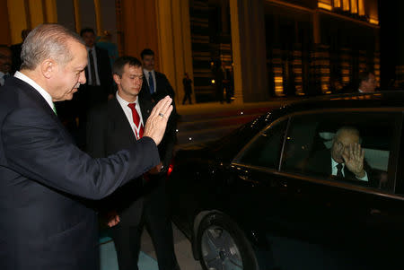 Turkish President Tayyip Erdogan greets his Russian counterpart Vladimir Putin as he leaves from the Presidential Palace in Ankara, Turkey, December 11, 2017. Kayhan Ozer/Presidential Palace/Handout via REUTERS