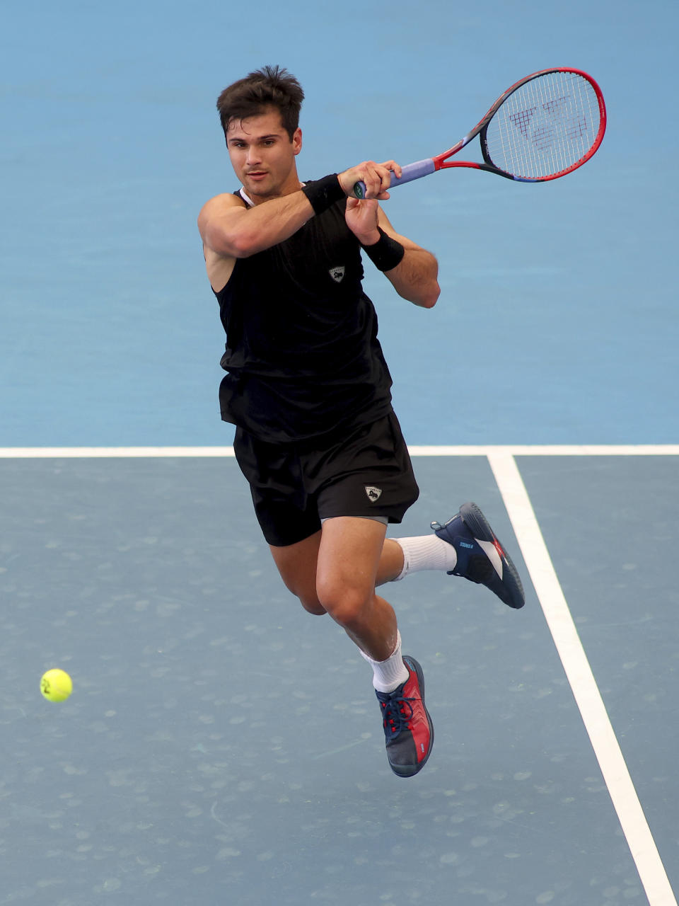 Marcos Giron of the United States makes a forehand return to Richard Gasquet of France during their Round of 32 match at the Adelaide International Tennis tournament in Adelaide, Australia, Sunday, Jan. 1, 2023. (AP Photo/Kelly Barnes)