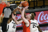 Central Florida forward C.J. Walker (21) blocks a shot-attempt by Auburn guard Justin Powell, center, as Central Florida guard Dre Fuller Jr., right, comes in to help during the second half of an NCAA college basketball game, Monday, Nov. 30, 2020, in Orlando, Fla. (AP Photo/John Raoux)