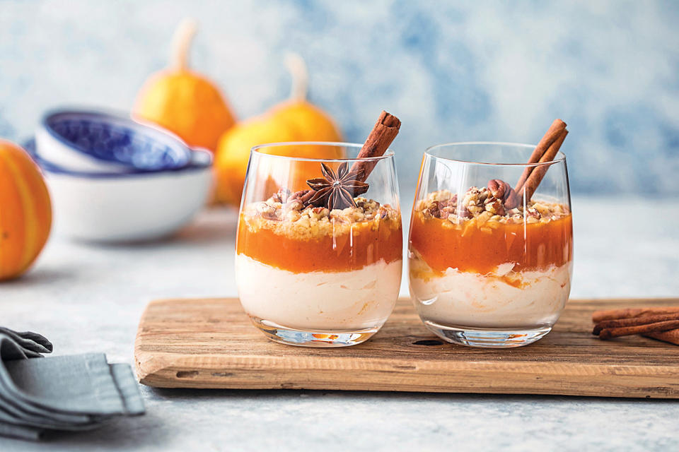 Dessert party: spiced fall pumpkin parfaits on wooden tray 