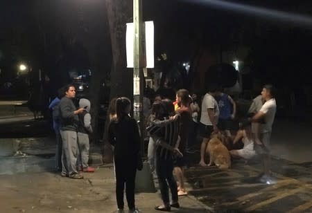 Residents react after an earthquake was felt in Mexico City