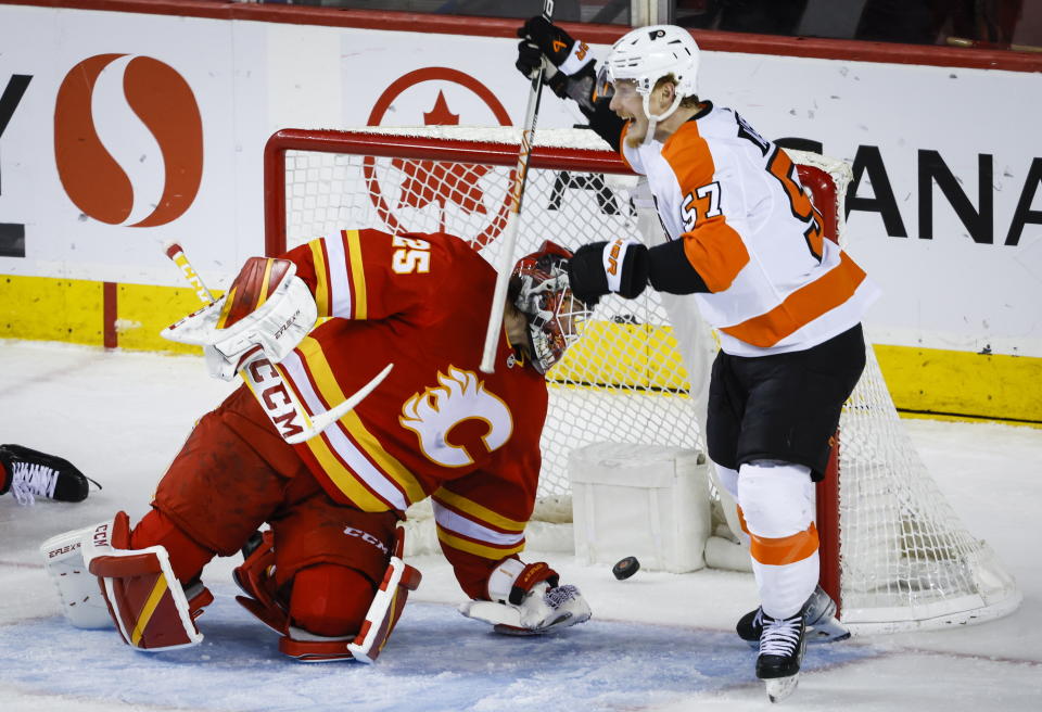 Philadelphia Flyers forward Wade Allison, right, celebrates after his goal as Calgary Flames goalie Jacob Markstrom reacts during second-period NHL hockey game action in Calgary, Alberta, Monday, Feb. 20, 2023. (Jeff McIntosh/The Canadian Press via AP)