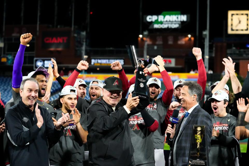 Arizona Diamondbacks owner Ken Kendrick hoists the National League Championship Series trophy after defeating the Philadelphia Phillies in game seven of the NLCS at Citizens Bank Park in Philadelphia on Oct. 24, 2023.