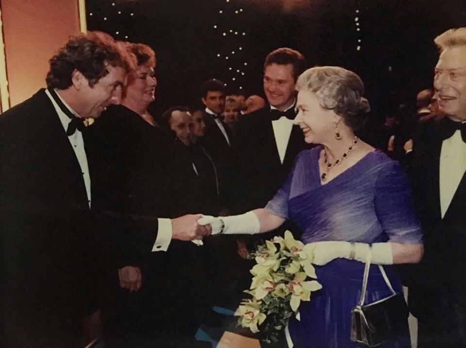 Idle shakes hands with Queen Elizabeth II.<span class="copyright">Courtesy Photo</span>