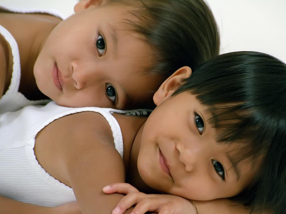 Isabella and Olivia Solimene pose together soon after they were adopted as little girls.