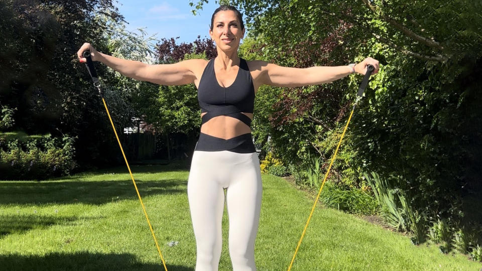 Rachael Sacerdoti demonstrating the resistance band lateral raise