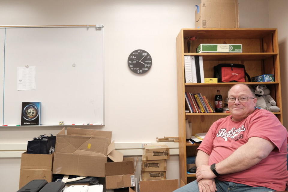 Math teacher Steve Mosley sits in his classroom at Ben Eielson Junior Senior High School on April 22, 2024. He has mostly packed his materials in anticipation of moving to North Pole HIgh School next year. "Very sad to see the school close. It had a really important impact in the community and especially on base kids. They come in and out of here every three years for the most part, so it was a good place for them to gather with their peers the smaller school environment," he said. (Photo by Claire Stremple/Alaska Beacon)