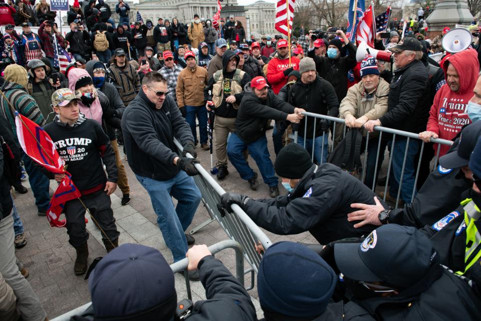 Demonstrators breach security fencing.