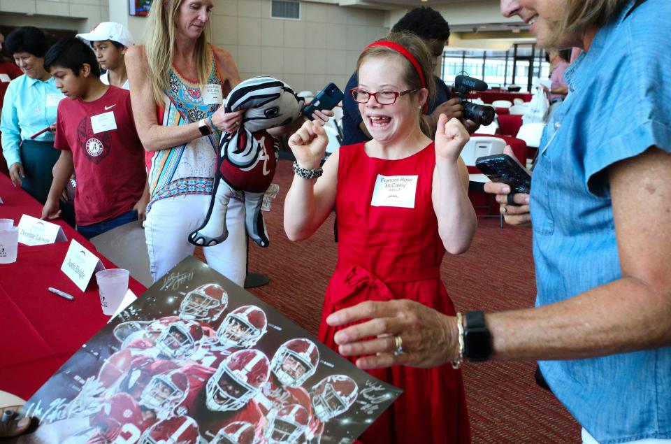 Frances Rose McCalley is jubilant as she gets autographs from Alabama players during the Nick's Kids Foundation luncheon Wednesday  Aug. 2, 2023, in Bryant-Denny Stadium.