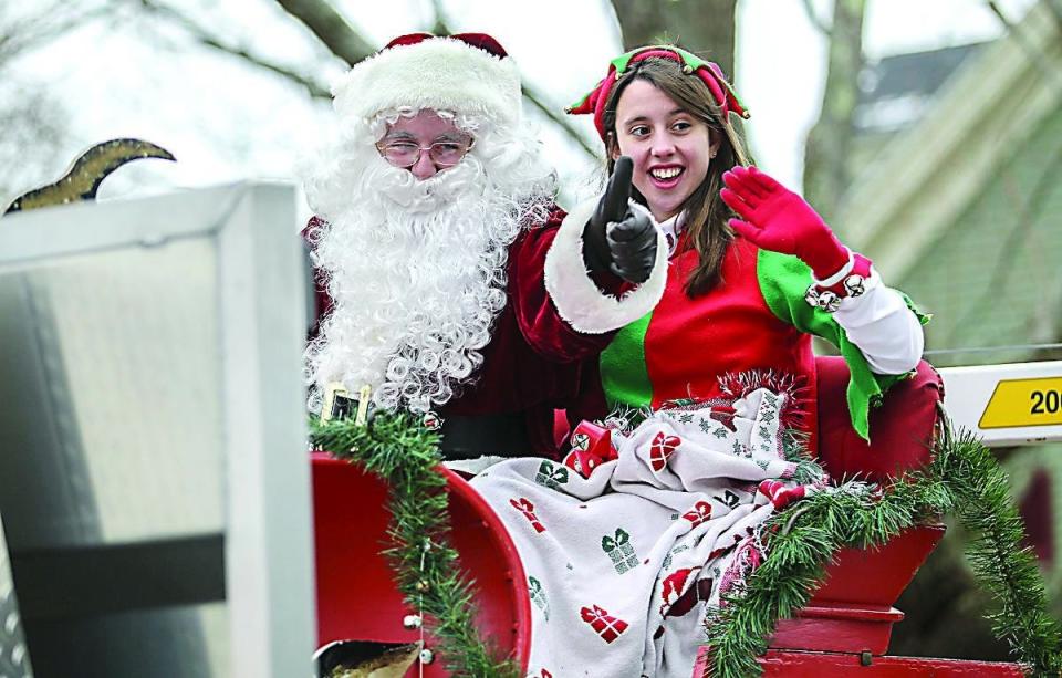 Santa and one of his elves wave to the people lining the street Sunday at the end of the Old-fashioned New England holiday parade in Rye, in this Portsmouth Herald file photo from 2013.