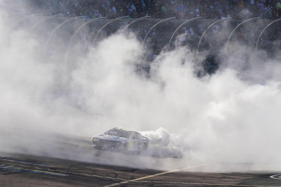 William Byron does a burnout after winning a NASCAR Cup Series auto race at Phoenix Raceway, Sunday, March 12, 2023, in Avondale, Ariz. (AP Photo/Darryl Webb)