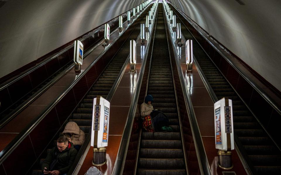 Civilians take shelter at a Kyiv metro station - DIMITAR DILKOFF/AFP