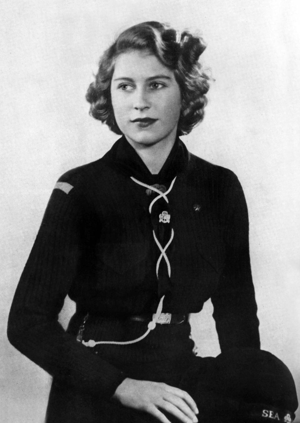 Princess Elizabeth of England (future queen Elizabeth II) young wearing girl scout uniform (she's member of the Buckingham Palace Company of Girl Guides) in 1943