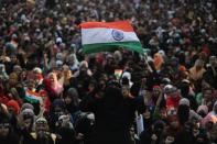 A demonstrator waves the Indian national flag during a protest against a new citizenship law on the outskirts of Mumbai