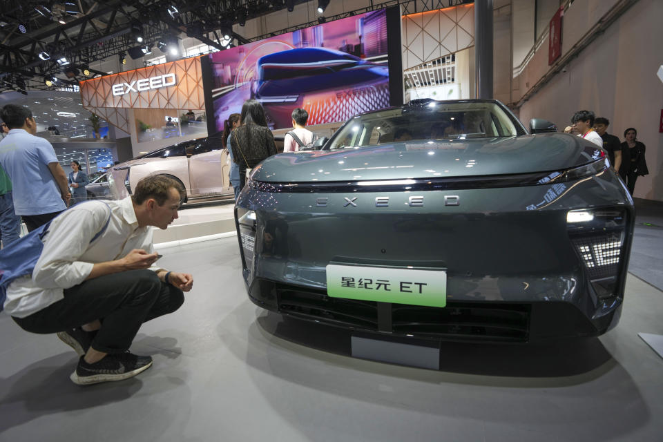 A visitor looks at an Exeed ET car during China Auto Show in Beijing, China, Friday, April 26, 2024. China's vision of the future of the automobile electrified and digitally connected is on display at the ongoing Beijing auto show. (AP Photo/Tatan Syuflana)