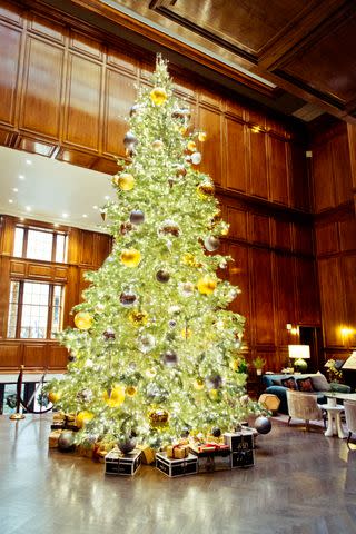 <p>Gabriela Herman</p> A 25-foot-tall fir tree sparkles at the grand entrance.