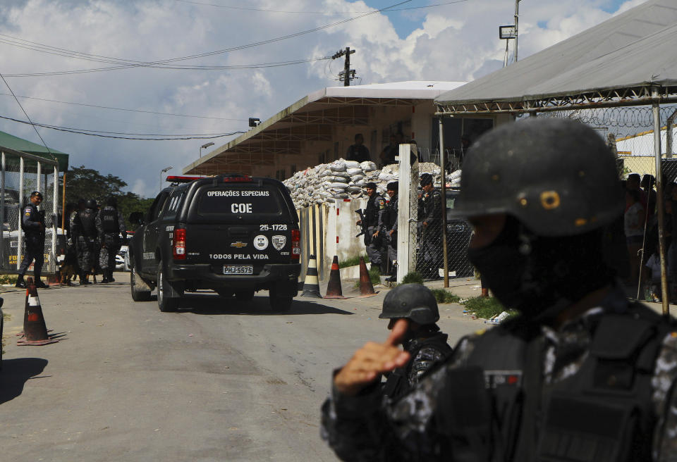 Police guard the entrance to the Anisio Jobim Prison Complex after a deadly riot erupted among inmates in Manaus in the northern state of Amazonas, Brazil, Sunday, May 26, 2019. A statement from the state prison secretary says prisoners began fighting among themselves around noon Sunday, and security reinforcements were rushed to complex. (AP Photo/Edmar Barros)