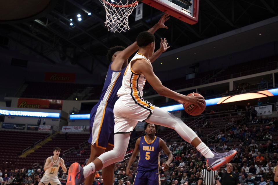 Archbishop Wood sophomore Jalil Bethea passes under the hoop at Giant Center in Hershey on Saturday, March 26, 2022. Archbishop Wood boys basketball fell to Roman Catholic in PIAA championship final in class 6A, 77-65.